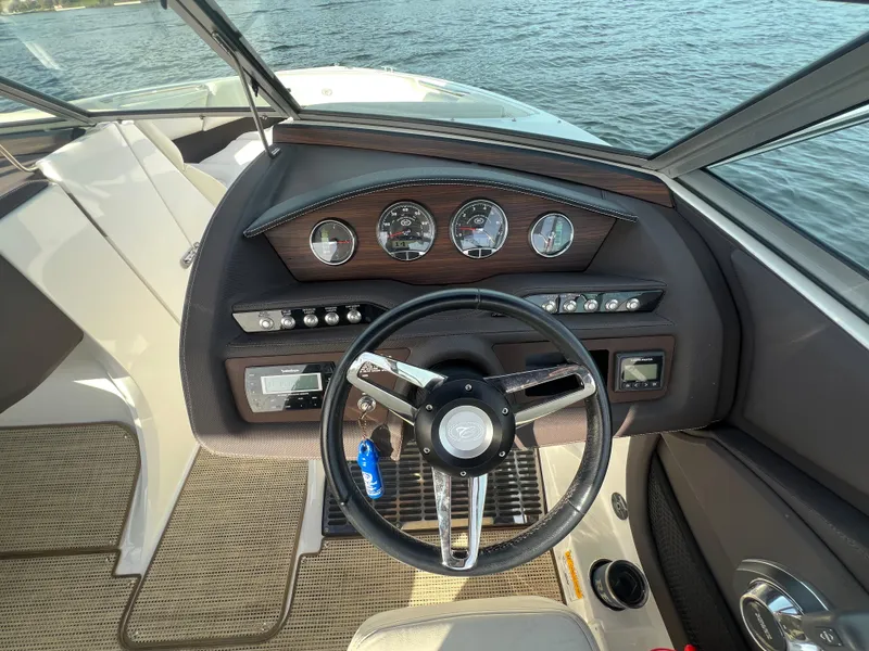 Slide: The Image of Steering wheel and dashboard of a 2015 Cobalt R3 boat on the water. - 20