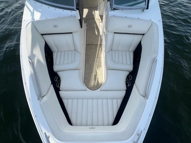 Slide: The Image of 2015 Cobalt R3 boat interior with white cushioned seating and cup holders. - 23