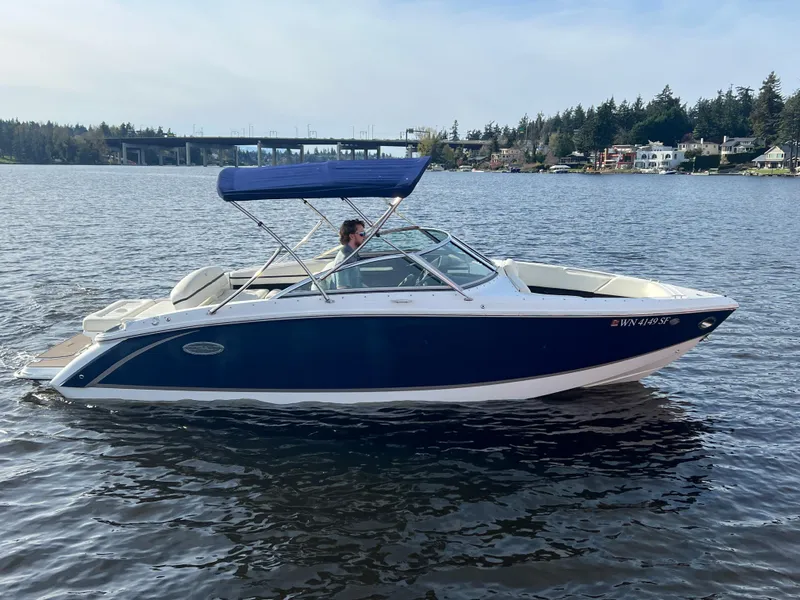 Slide: The Image of 2015 Cobalt R3 boat on calm water with blue canopy, scenic background. - 5
