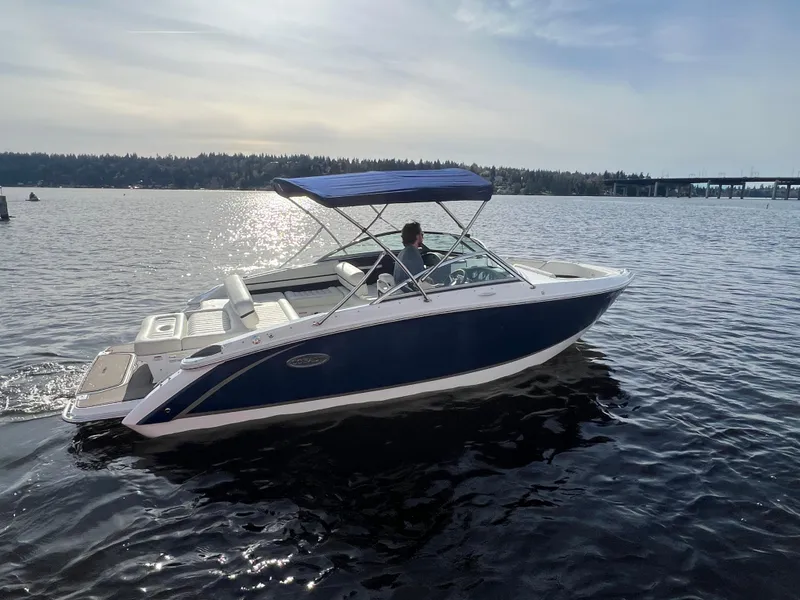 Slide: The Image of 2015 Cobalt R3 boat cruising on a sunny lake with a blue canopy. - 6