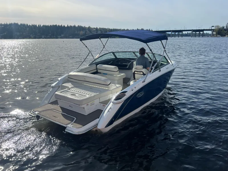 Slide: The Image of 2015 Cobalt R3 boat cruising on a sunny lake with a blue canopy. - 7