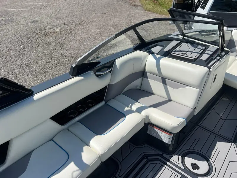 Slide: The Image of 2022 Moomba Mojo boat interior with white seating and open windshield. - 13