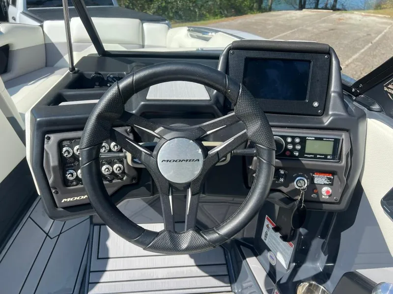 Slide: The Image of 2022 Moomba Mojo boat dashboard with steering wheel and control panel. - 15