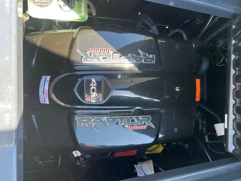 Slide: The Image of 2022 Moomba Mojo engine, featuring Raptor Indmar 400, in a boat compartment. - 16