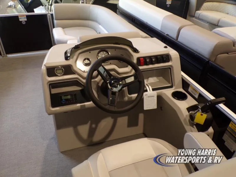 Slide: The Image of 2025 Godfrey EX2286SB boat interior with steering console and seating. - 4