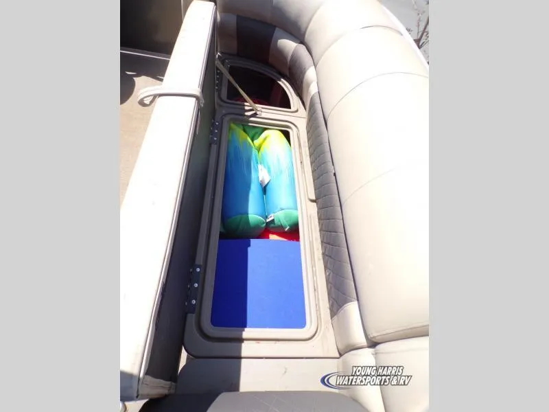 Slide: The Image of 2020 Sun Tracker Party Barge 20DLX storage compartment with colorful inflatables inside. - 11