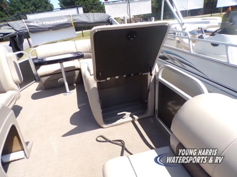 Slide: The Image of 2020 Sun Tracker Party Barge 20DLX interior with open storage compartment and seating. - 12