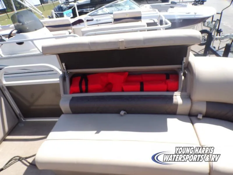 Slide: The Image of 2020 Sun Tracker Party Barge 20DLX with open storage compartment showing life jackets. - 16