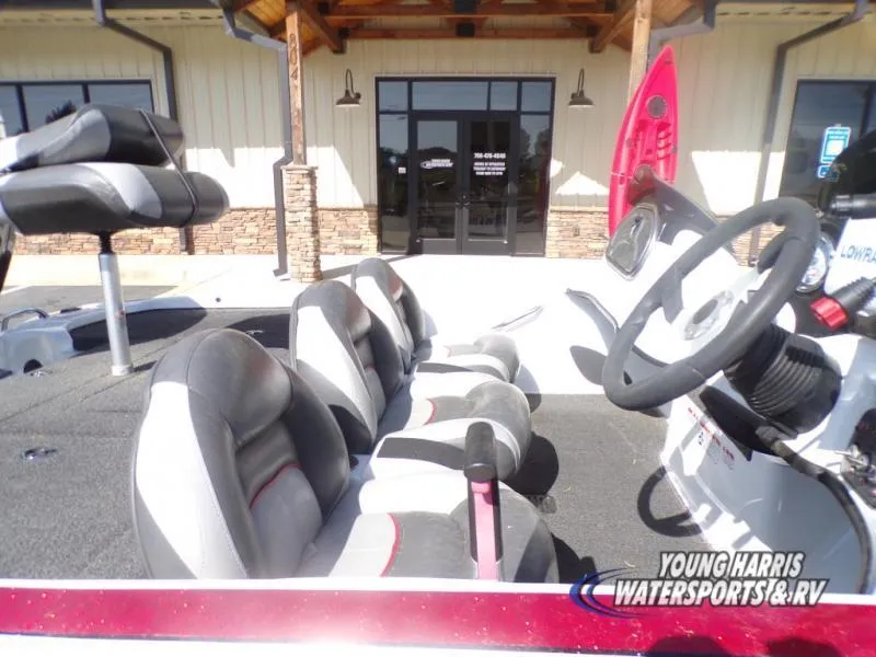 Slide: The Image of 2015 Tracker Nitro Z6 boat interior with seating and steering wheel, outside a building. - 6