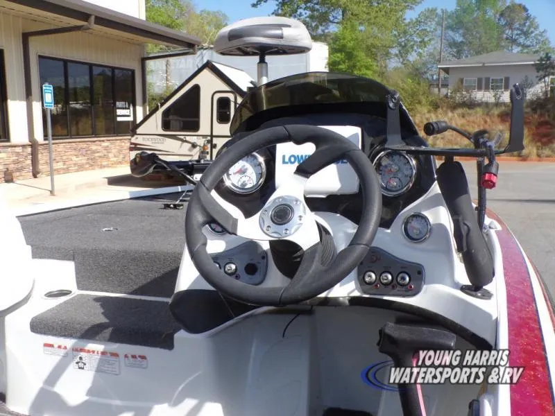 Slide: The Image of 2015 Tracker Nitro Z6 boat dashboard with steering wheel and controls. - 7
