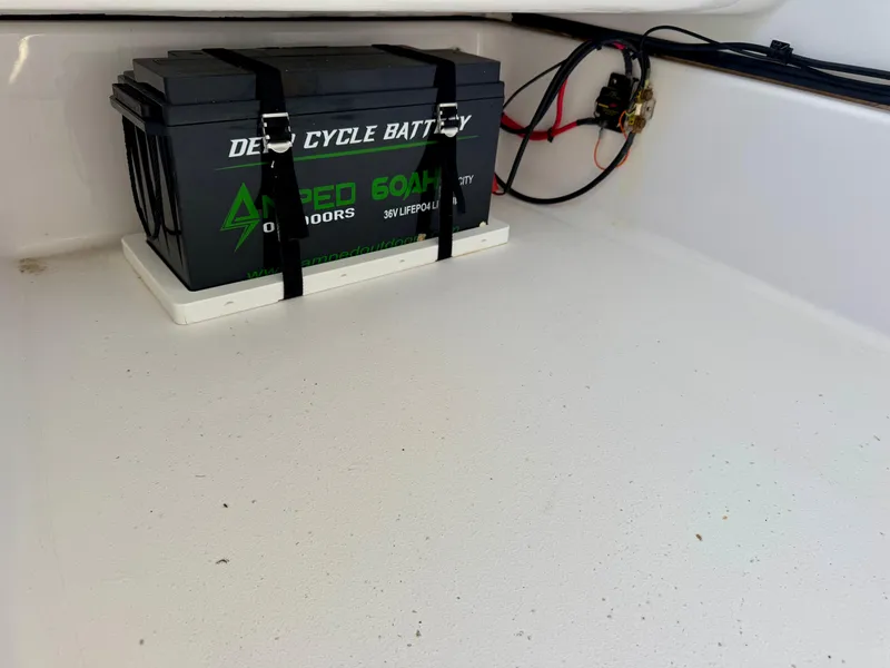Slide: The Image of Deep cycle battery in Sportsman 247OE boat, 2022 model, secured with straps. - 11