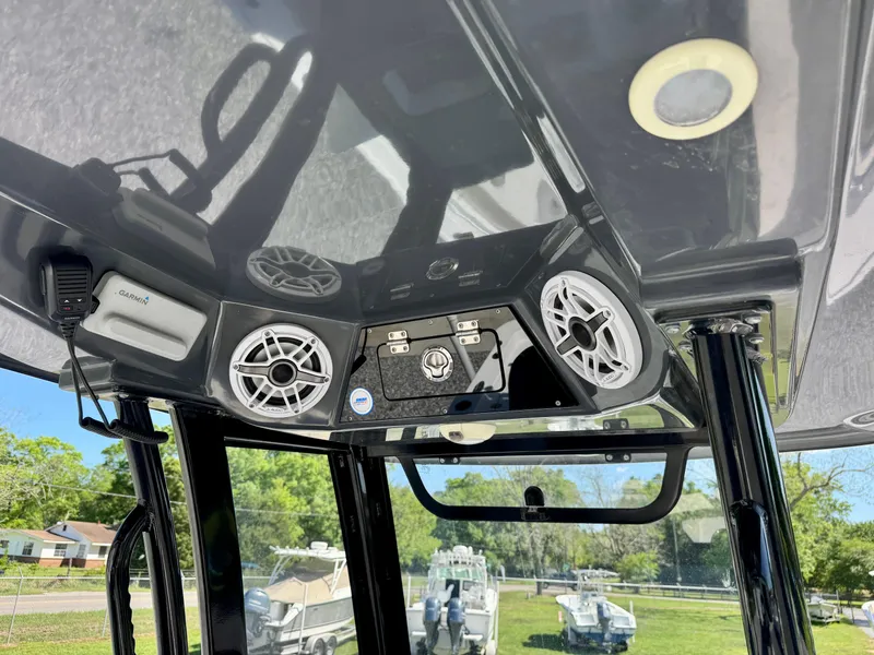 Slide: The Image of 2022 Sportsman 247OE boat console with speakers and controls, featuring a sleek black design. - 15