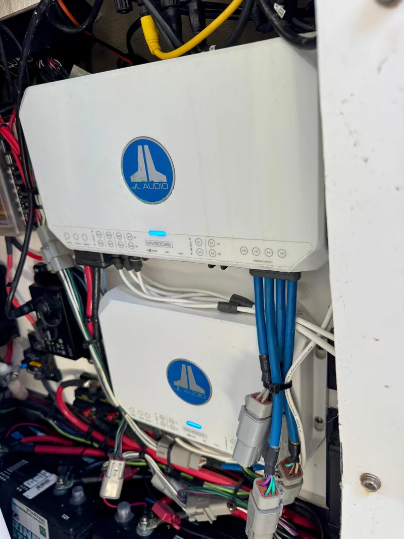 Slide: The Image of Electrical components in a 2022 Sportsman 247OE boat, featuring wiring and control units. - 17