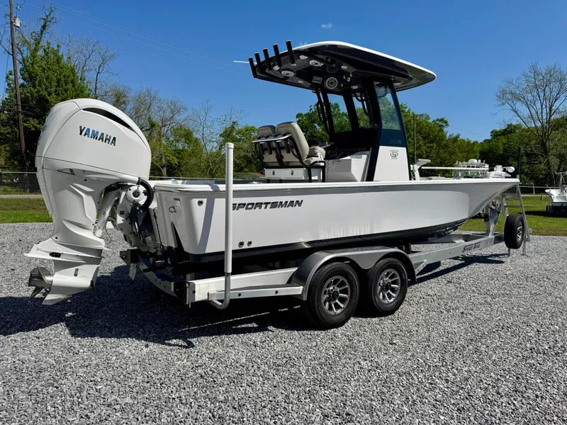 Slide: The Image of 2022 Sportsman 247OE boat with Yamaha engine on a trailer, parked on gravel. - 3