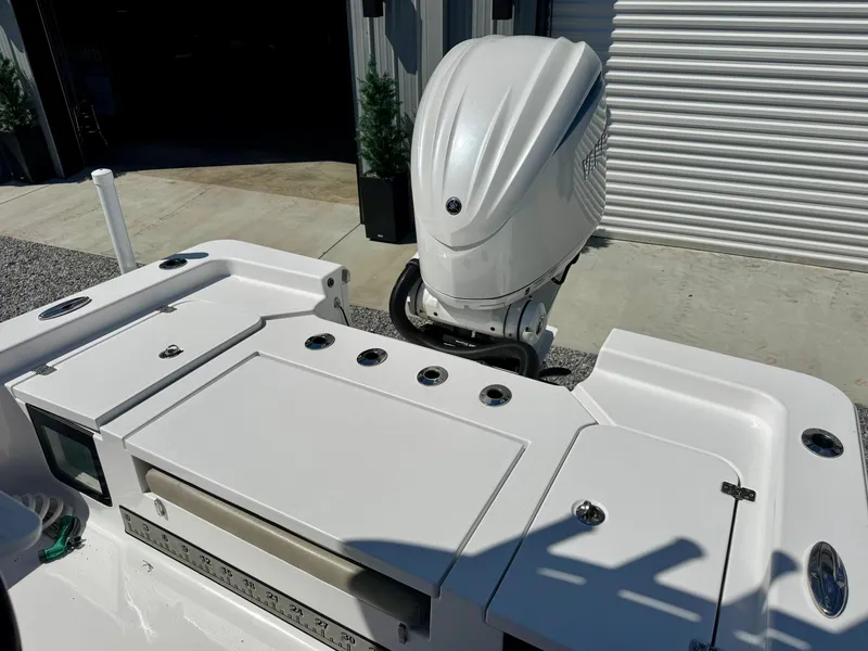Slide: The Image of 2022 Sportsman 247OE boat with outboard motor, featuring a sleek white deck design. - 8