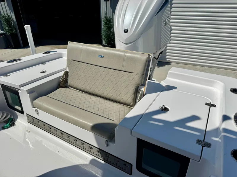 Slide: The Image of 2022 Sportsman 247OE boat with cushioned seating and storage compartments, featuring a sleek design. - 9