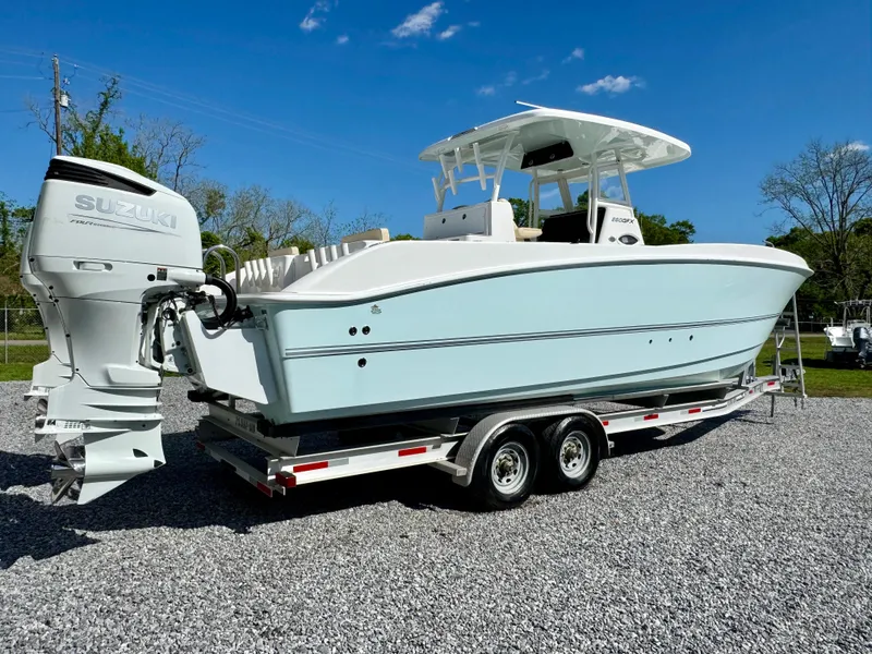 Slide: The Image of 2023 Twin Vee 280 GFX CC boat on trailer with Suzuki outboard motor. - 18