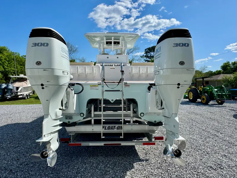 Slide: The Image of 2023 Twin Vee 280 GFX CC boat with dual 300 horsepower engines, rear view. - 20