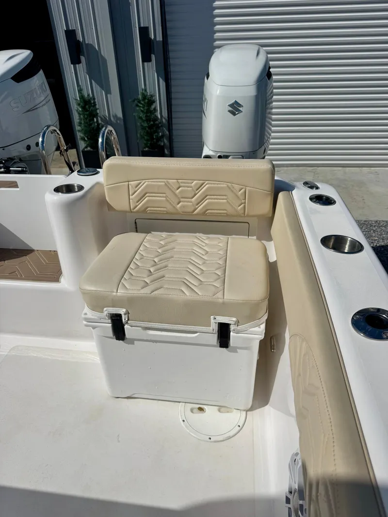 Slide: The Image of 2023 Twin Vee 280 GFX CC boat seat with beige cushion and cup holders. - 24