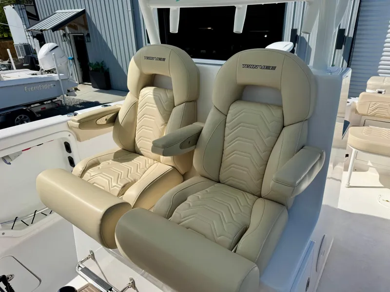 Slide: The Image of 2023 Twin Vee 280 GFX CC boat with luxurious beige captain seats. - 27