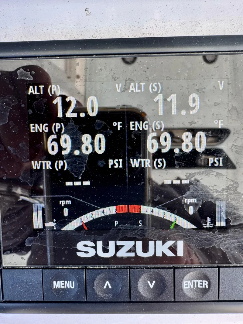Slide: The Image of Suzuki engine display showing altimeter, engine temperature, and water pressure on a 2023 Twin Vee 280 GFX CC. - 33