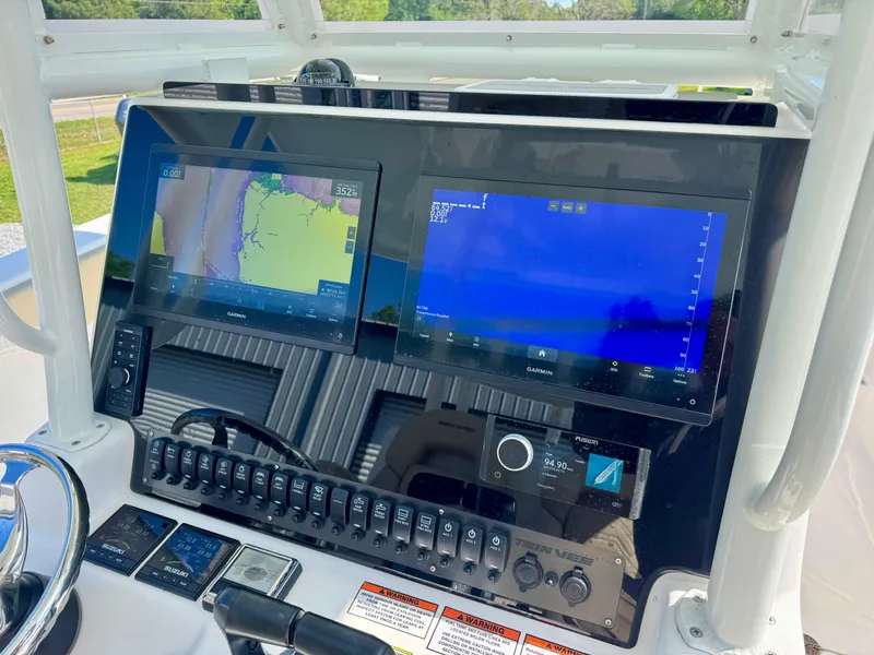 Slide: The Image of 2023 Twin Vee 280 GFX CC dashboard with dual navigation screens and control panel. - 35