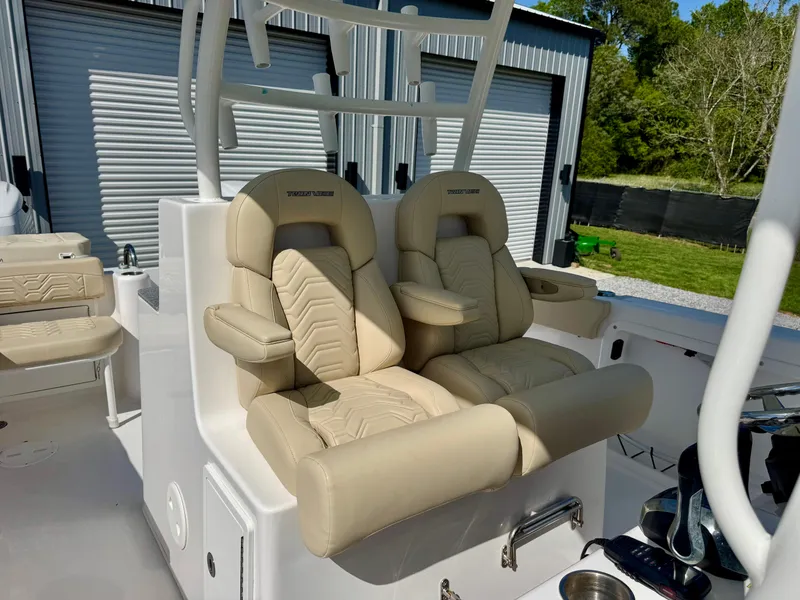 Slide: The Image of 2023 Twin Vee 280 GFX CC boat with beige captain seats and modern design. - 36