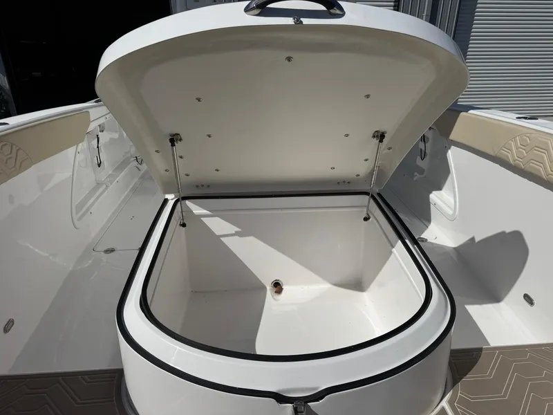 Slide: The Image of 2023 Twin Vee 280 GFX CC boat storage compartment open, showcasing spacious interior. - 37