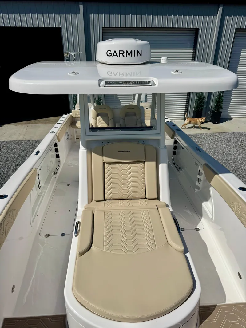 Slide: The Image of 2023 Twin Vee 280 GFX CC boat with Garmin equipment, featuring beige seating and sleek design. - 38