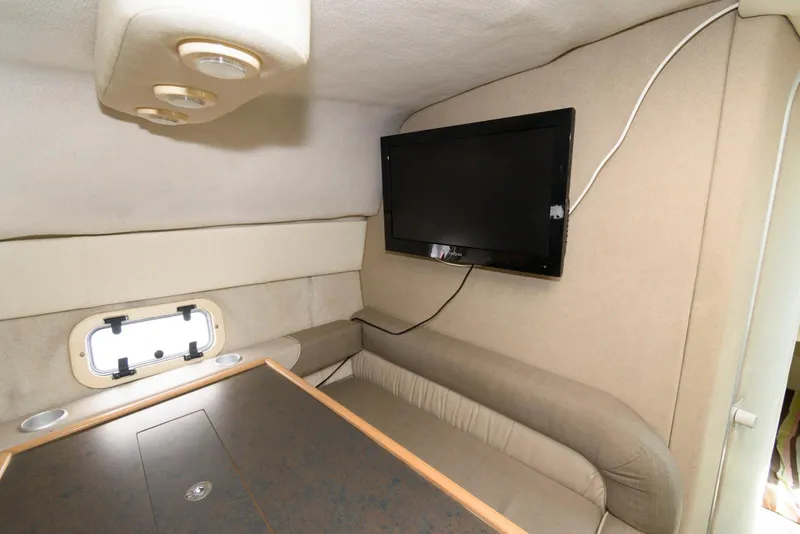 Slide: The Image of Interior of 1996 Maxum 2700 SCR boat with TV and seating area. - 11