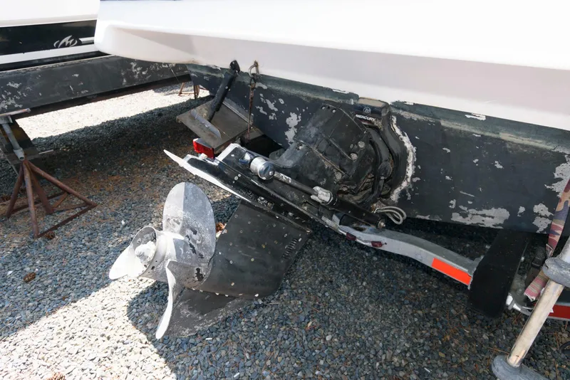 Slide: The Image of 1996 Maxum 2700 SCR boat stern with visible propeller and drive system. - 13