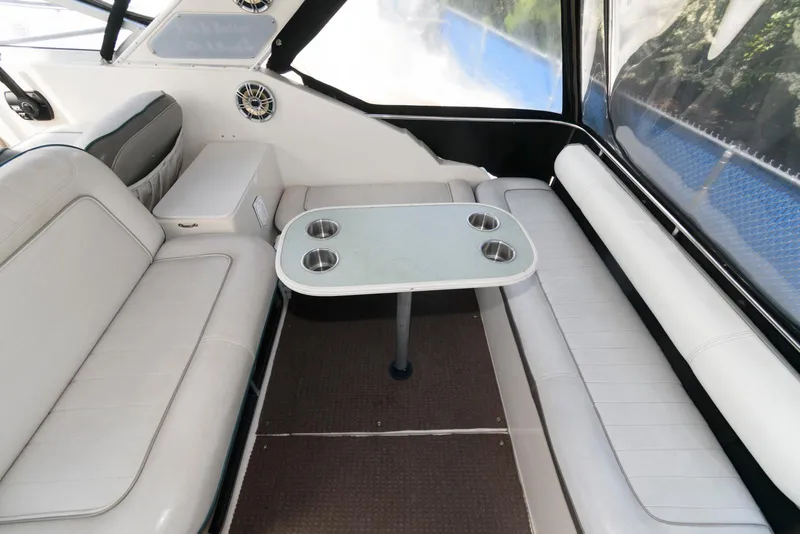 Slide: The Image of 1996 Maxum 2700 SCR boat interior with white seating and table. - 3