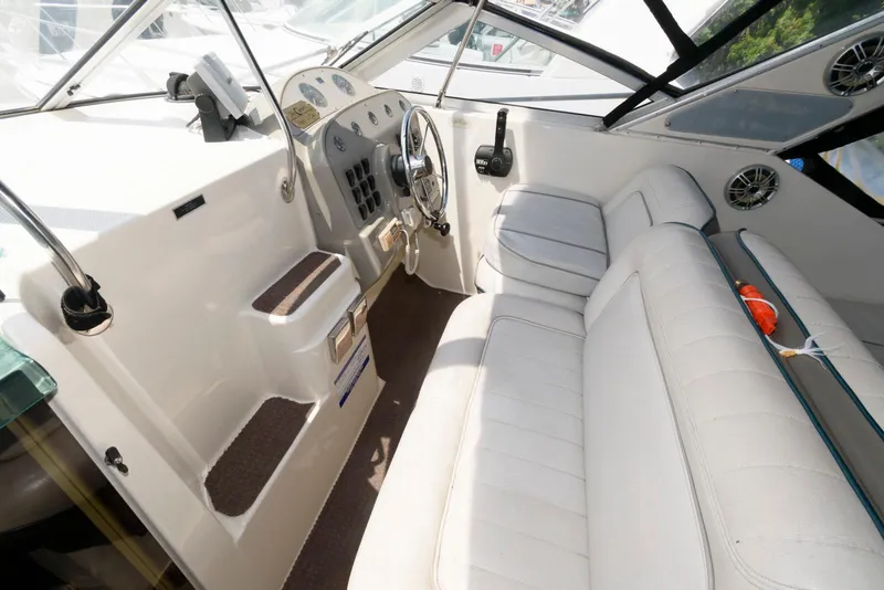 Slide: The Image of 1996 Maxum 2700 SCR boat interior with white seating and control panel. - 4