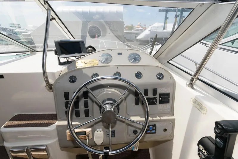 Slide: The Image of 1996 Maxum 2700 SCR boat dashboard with steering wheel and navigation instruments. - 5