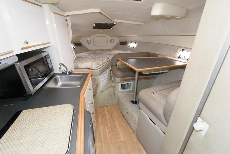 Slide: The Image of Interior of 1996 Maxum 2700 SCR boat with kitchenette and seating area. - 6