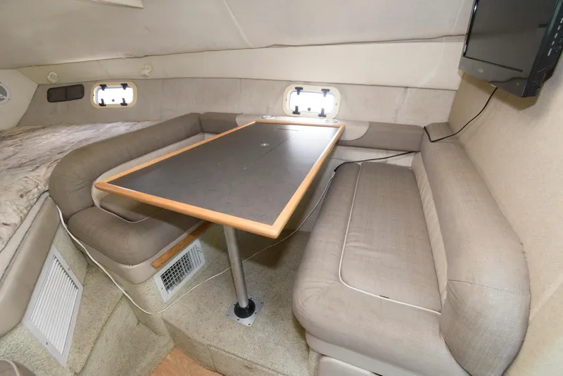 Slide: The Image of Interior of 1996 Maxum 2700 SCR boat with seating and table. - 8