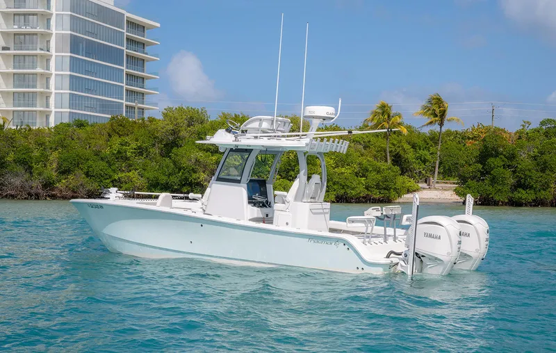 The Image of 2024 Freeman 28 boat on clear water, modern design, twin engines, tropical backdrop. - 0