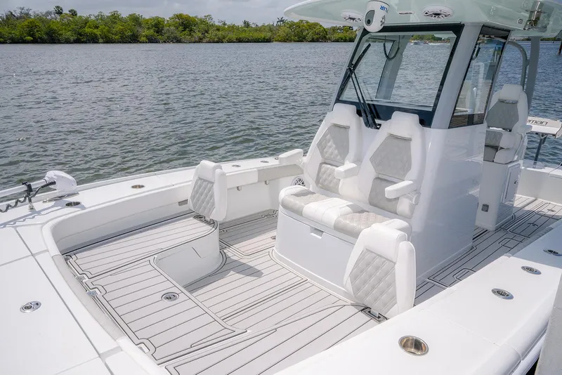 Slide: The Image of 2024 Freeman 28 boat interior with modern seating and sleek design on calm water. - 10