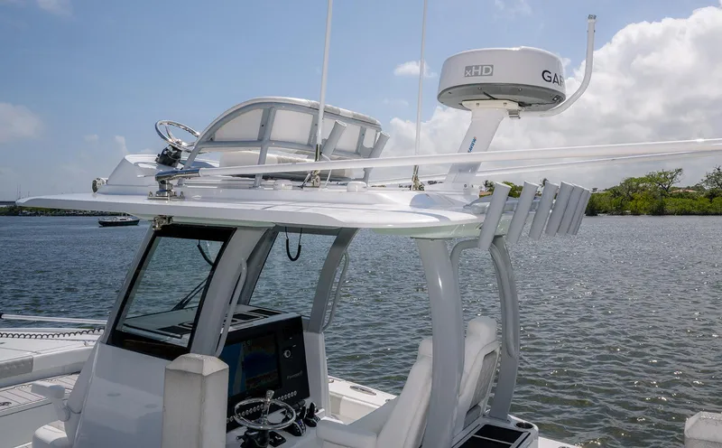 Slide: The Image of 2024 Freeman 28 boat with advanced navigation equipment on a calm waterway. - 13