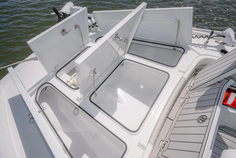 Slide: The Image of 2024 Freeman 28 boat with open storage compartments on deck. - 16