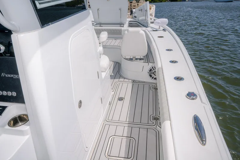 Slide: The Image of 2024 Freeman 28 boat deck with sleek design and modern features on the water. - 19