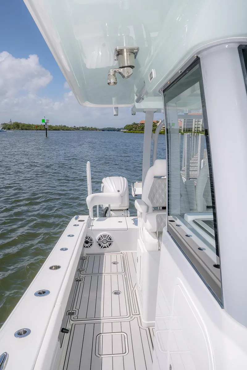 Slide: The Image of 2024 Freeman 28 boat, sleek design, spacious deck, cruising on calm waters. - 20