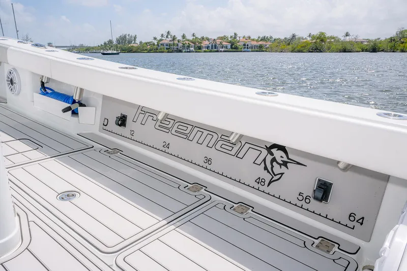 Slide: The Image of 2024 Freeman 28 boat deck with measurement markings, near a scenic waterfront. - 21