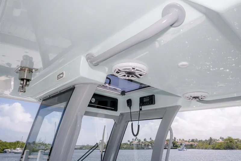 Slide: The Image of 2024 Freeman 28 boat interior with speakers and radio, overlooking a scenic waterfront. - 22