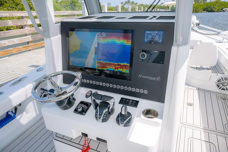 Slide: The Image of 2024 Freeman 28 boat dashboard with advanced navigation and control systems. - 23