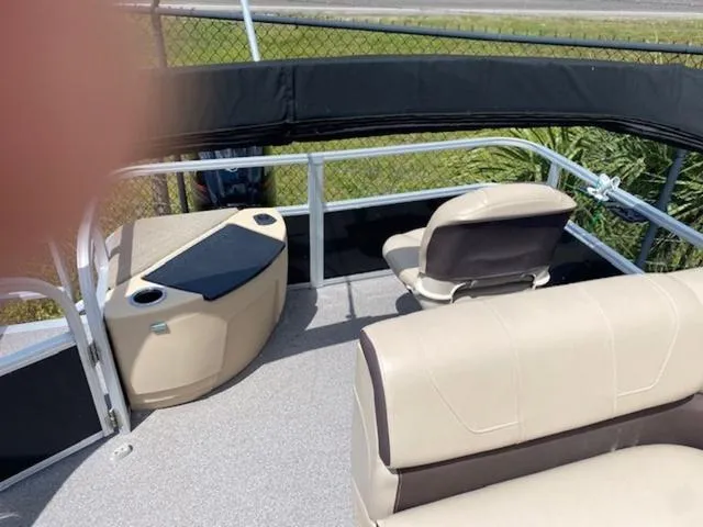 Slide: The Image of 2018 Sun Tracker FISHIN' BARGE® 20 DLX interior with seating and storage compartments. - 4