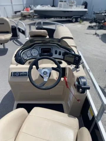 Slide: The Image of 2018 Sun Tracker FISHIN' BARGE® 20 DLX boat interior with steering console and seating. - 5