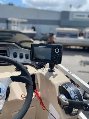 Slide: The Image of 2018 Sun Tracker FISHIN' BARGE® 20 DLX dashboard with steering wheel and fish finder. - 6