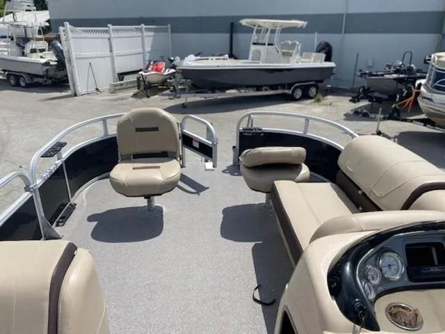 Slide: The Image of 2018 Sun Tracker FISHIN' BARGE® 20 DLX pontoon boat interior with seating and control panel. - 7