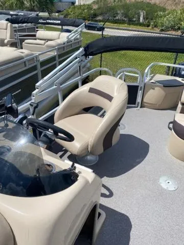 Slide: The Image of 2018 Sun Tracker FISHIN' BARGE® 20 DLX pontoon boat with beige seating and steering console. - 8